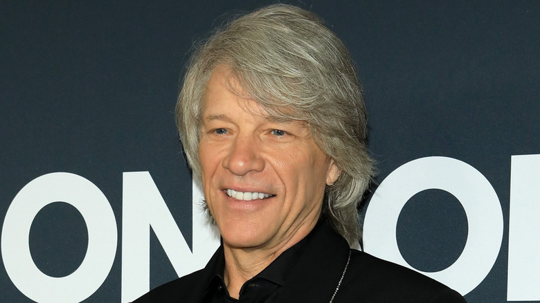 Jon Bovi Jovi smiles at an event