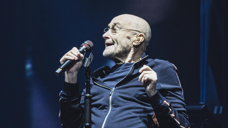 Phil Collins singing with a microphone
