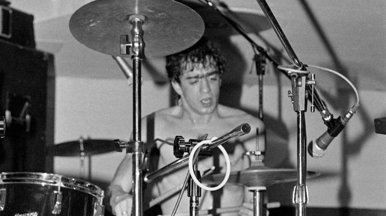 Bill Berry of R.E.M. playing drums on stage
