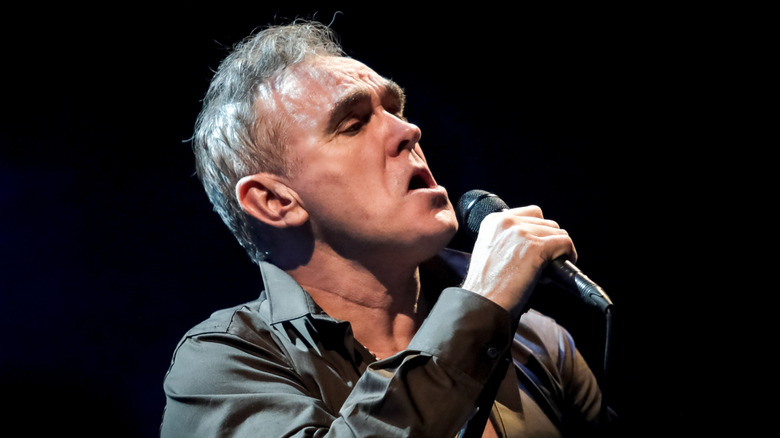 Morrissey on stage with a microphone.