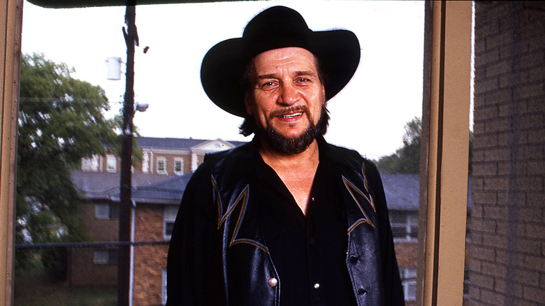 Waylon Jennings smiling in hat