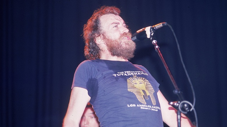 Joe Cocker singing on stage and contorting body and sweating