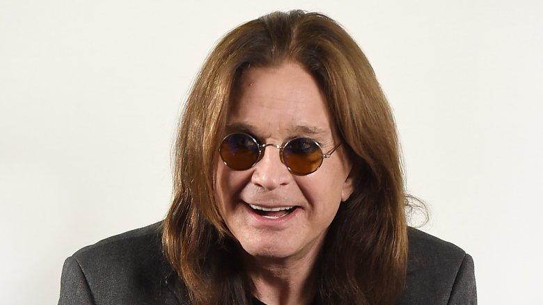 Ozzy Osbourne smiling in sunglasses