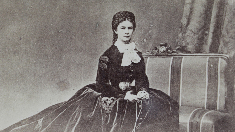 Photograph of Elisabeth of Austria siting on a sofa