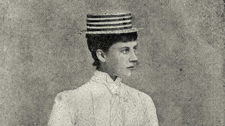 princess charlotte in striped hat and white shirt looking sideways