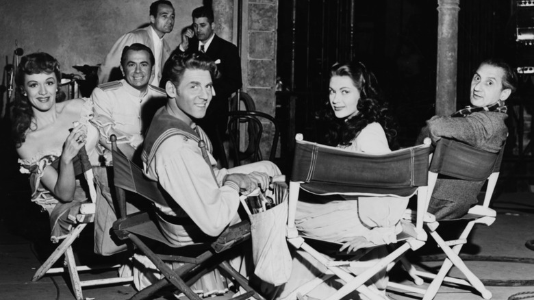 Eve Arden, Charles Kullman, Jean Aumont, Yvonne de Carlo, and Walter Reisch seated on film set