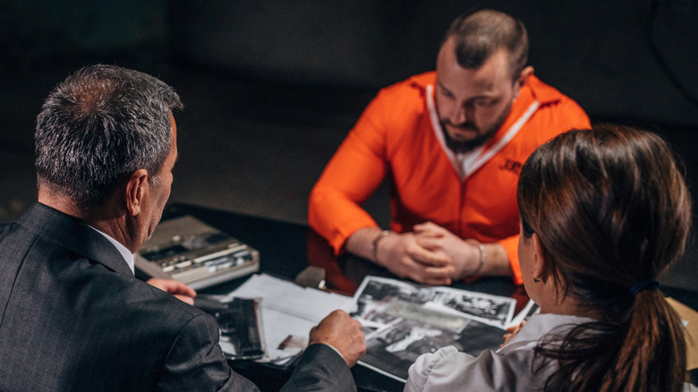 A witness being interrogated by two government officials