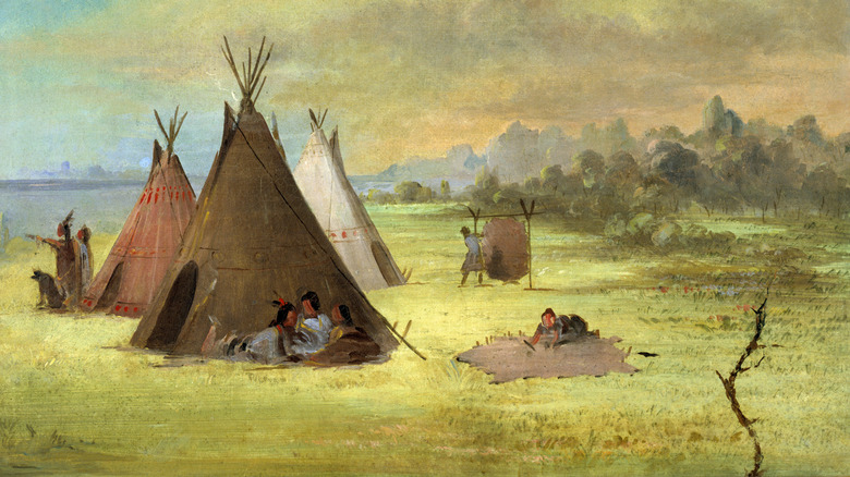 Comanche work near erected teepees