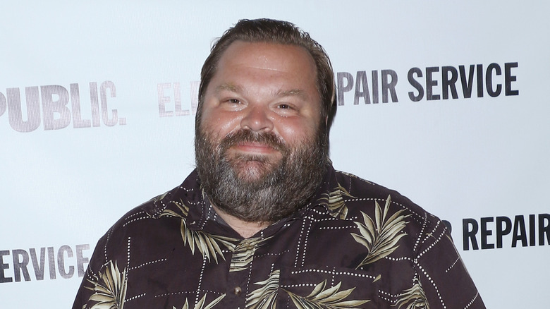 Mike Daisey smirking to camera