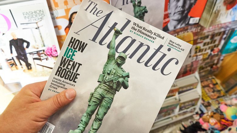 hand holding The Atlantic copy at a newstand