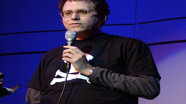 Stephen Glass holding microphone on stage