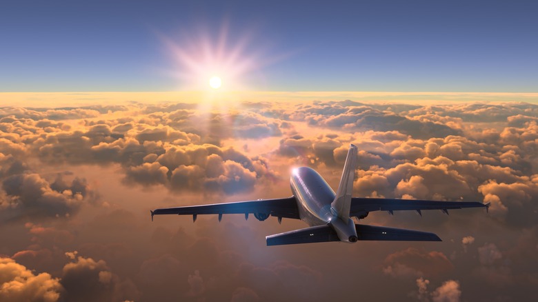 Jet flying into sunset