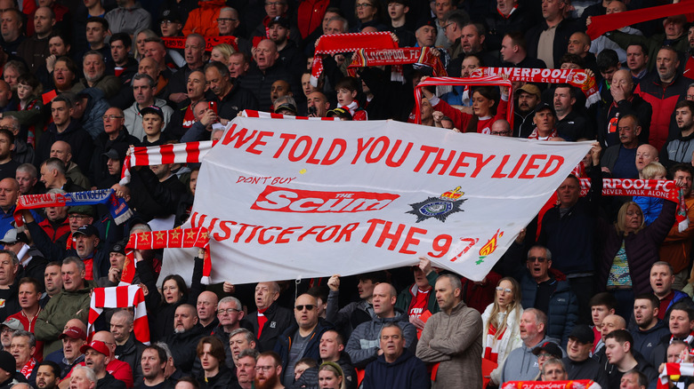 Liverpool supporters lift a banner in remembrance of the 1989 Hillsborough disaster