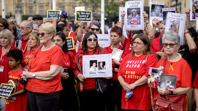 People affected by the infected blood scandal attend a vigil in London's Parliament Square in May 2024