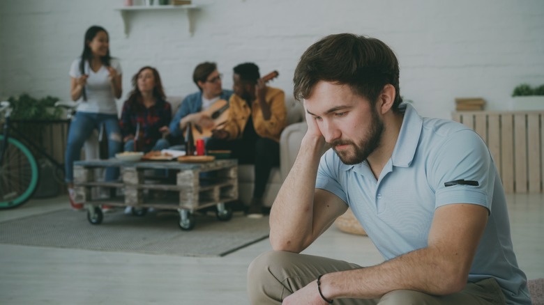 Guy sitting alone at party