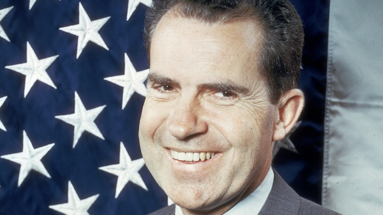 Richard Nixon smiling American flag