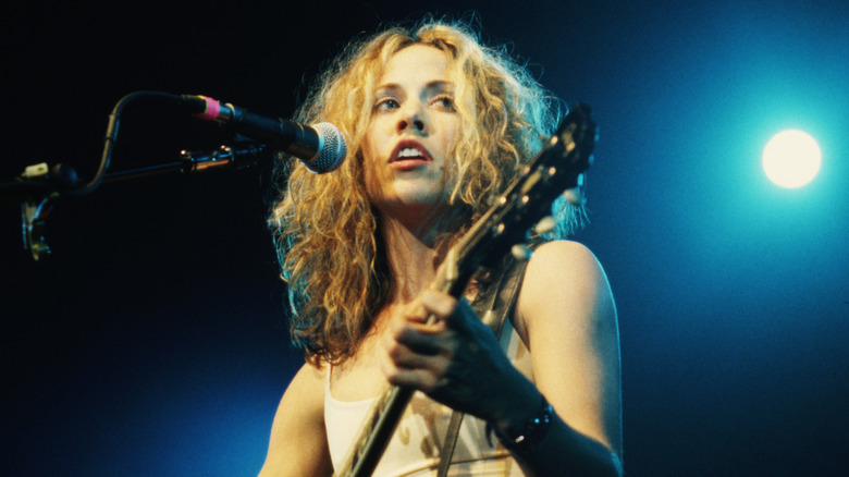 Sheryl Crow playing on stage in the 90s