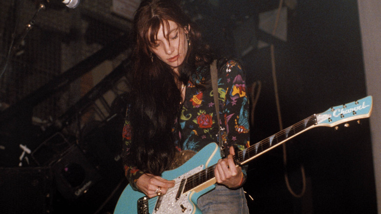 Bilinda Butcher on stage playing guitar