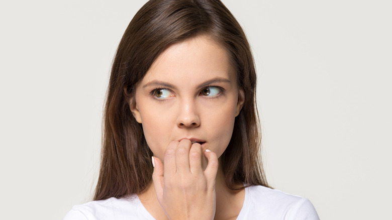 woman hands in mouth