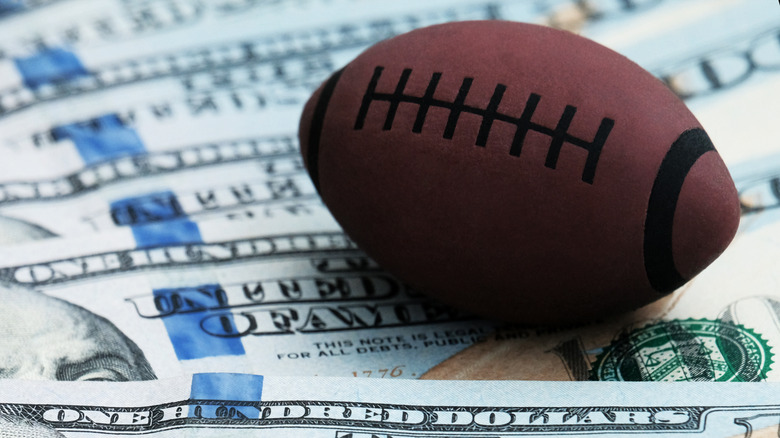 a football on a pile of money