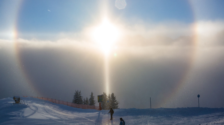 sun halo over skiers