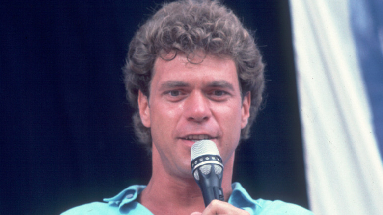 Joe Piscopo sweating with microphone on stage
