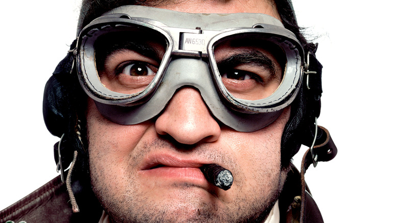 John Belushi in goggles with cigar
