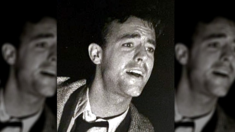 Peter Aykroyd headshot in tweed jacket and black tie
