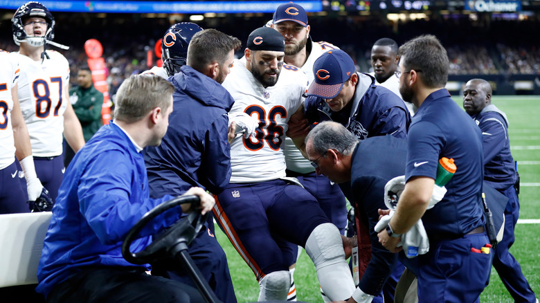 zach miller is helped off the field after sustaining knee injury
