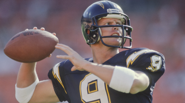Jim McMahon holding football