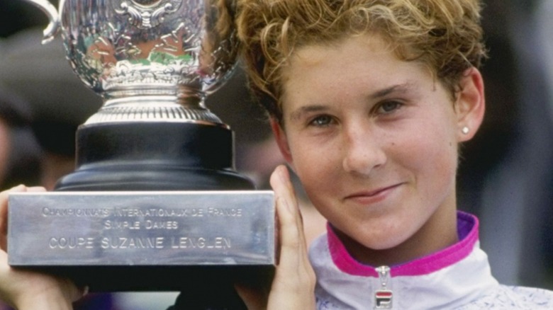Monica Seles holding French Open trophy