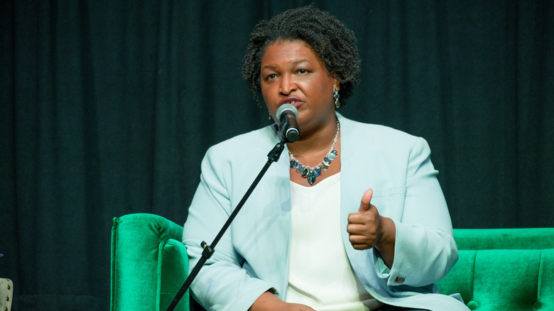 Stacey Abrams speaking into mic