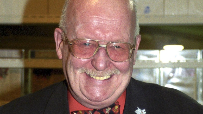 michael sheard glasses black suit laughing