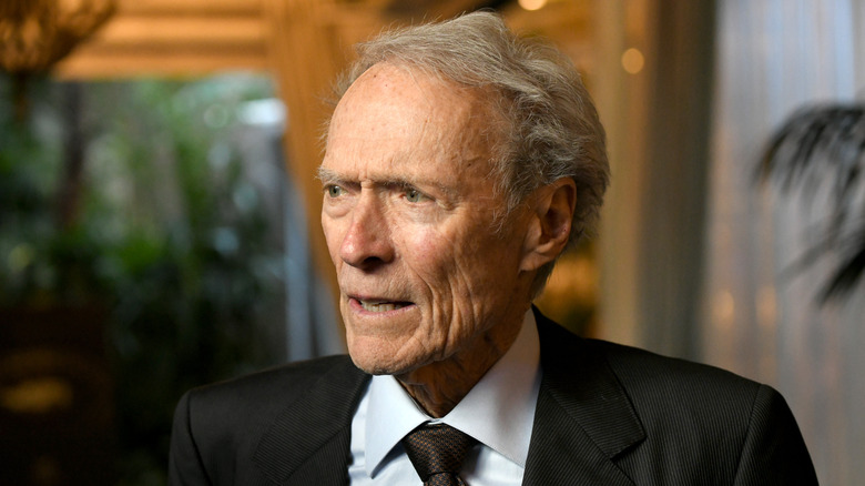 Elderly Clint Eastwood black suit at event