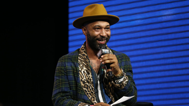 Joe Budden hat beard mic talking on stage