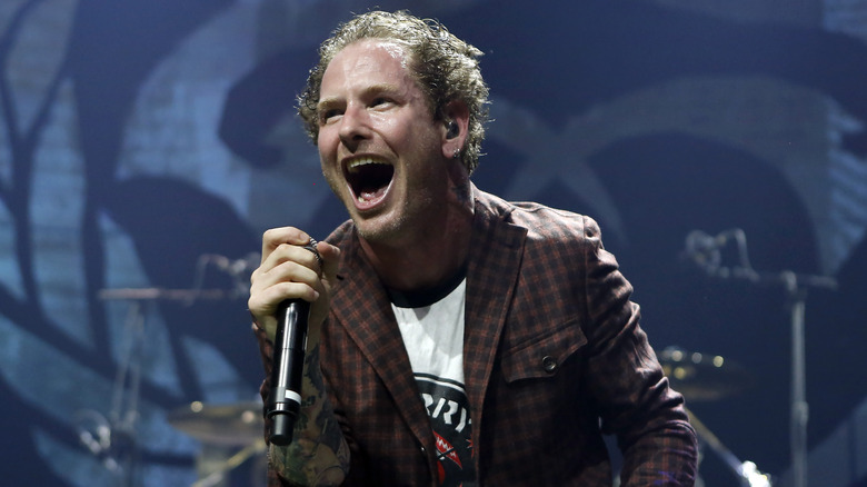 Corey Taylor holding mic singing on stage