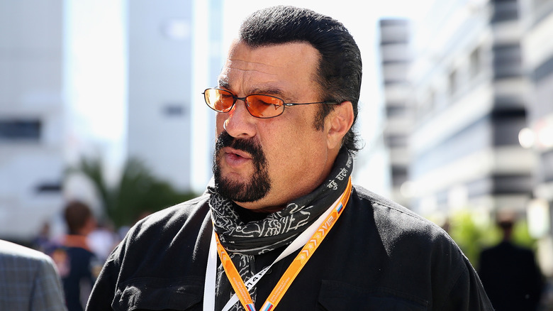 Steven Seagal in a black bandana and orange sunglasses