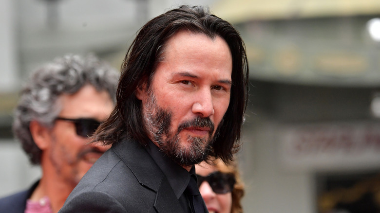 Keanu Reeves in dark suit