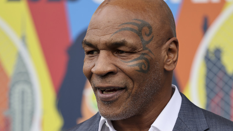 Mike Tyson smiling in grey suit