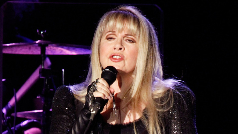 Stevie Nicks on stage in a shawl
