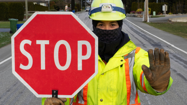 Woman holding stop sign