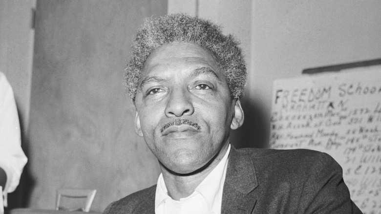 Bayard Rustin sitting in dark suit