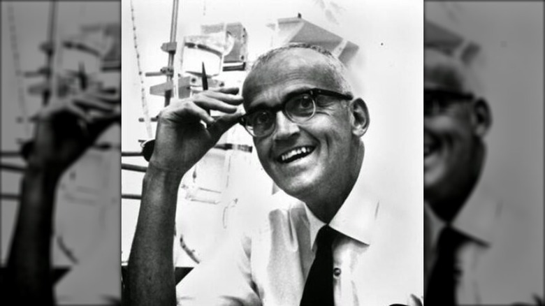 Clair Patterson smiling in white shirt and dark glasses