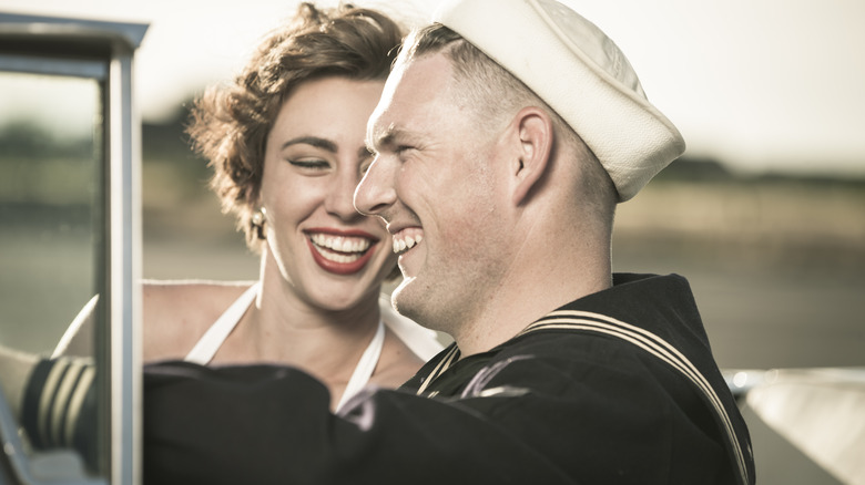 1950s-era couple riding in a car