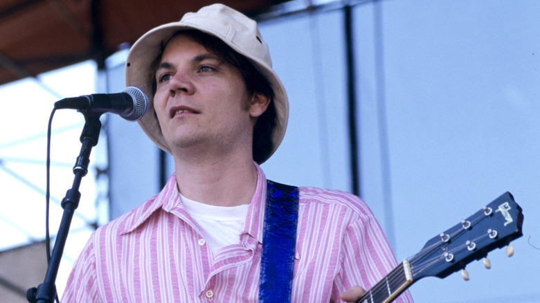 Jeff Tweedy performing with Wilco in a bucket hat