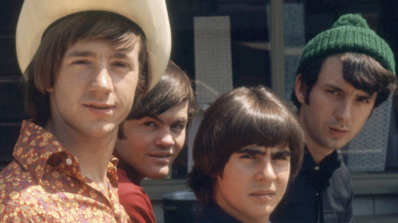 The Monkees glaring at camera outside sunlit