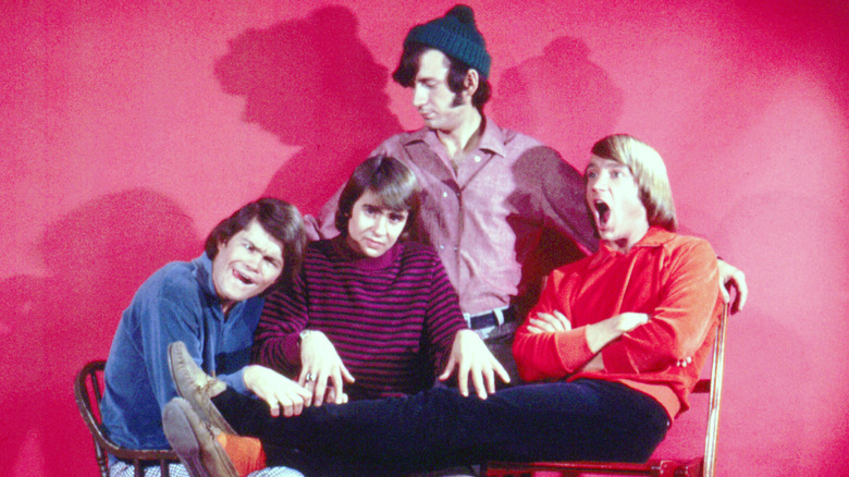 The Monkees with a red backdrop