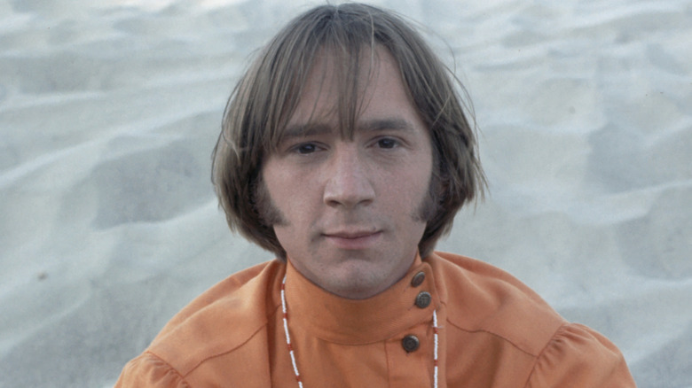 Peter Tork on a beach in orange shirt