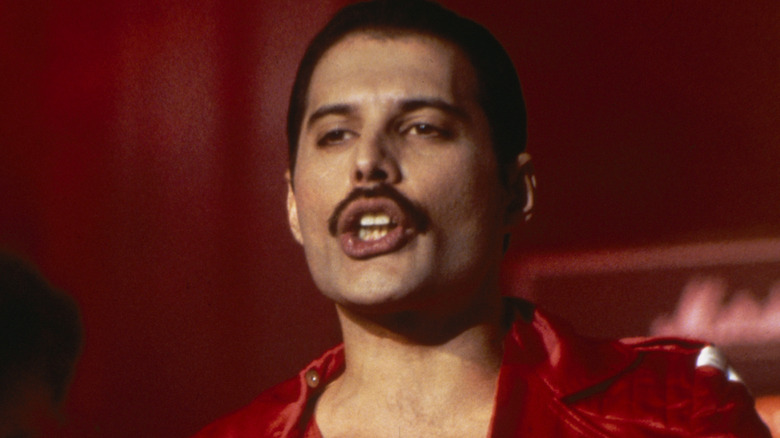 Freddie Mercury singing in a red suit in 1984