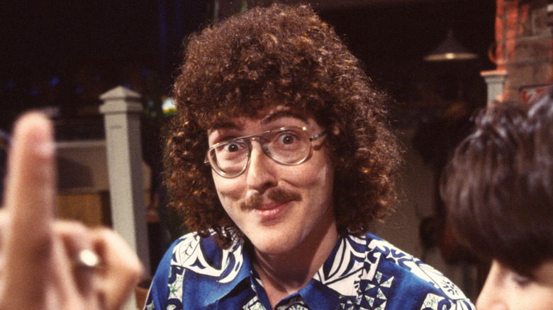 Weird Al Yankovic smiling in the 1980s at MTV studios